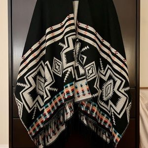 Gorgeous and soft wool-feel reversible shawl with fringe.